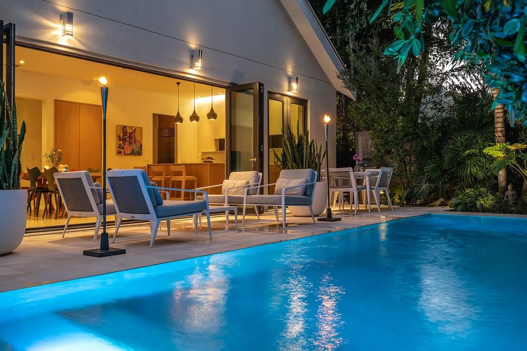 1025 Von Phister Street, Key West, Florida, is located in a sought-after neighborhood offering a tranquil escape. Both in the front and back yards, it is surrounded by lush tropical gardens.