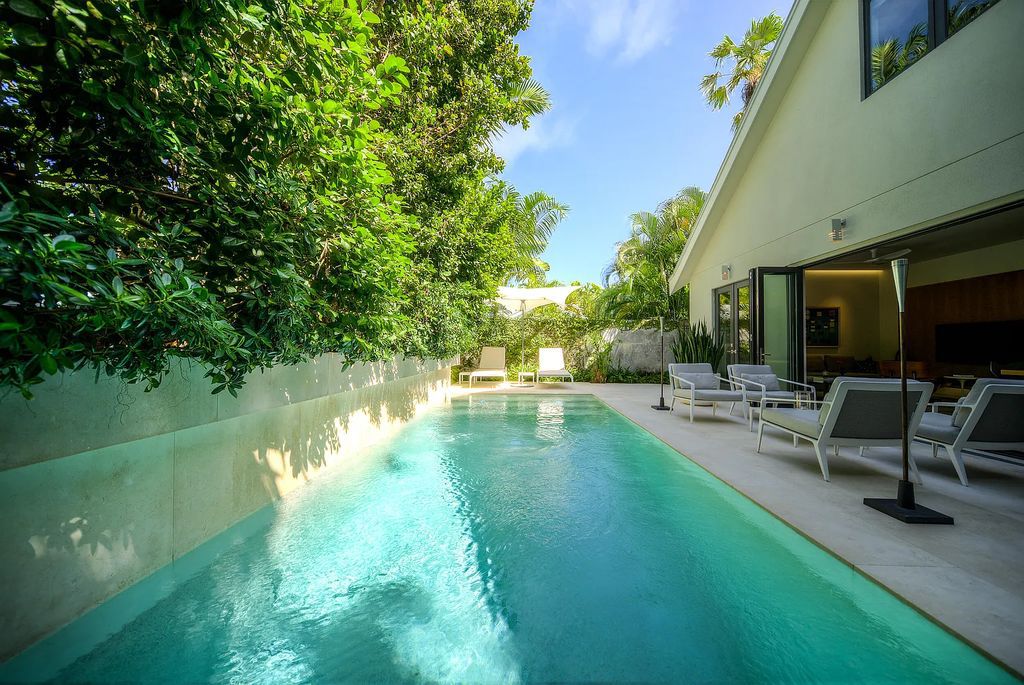 1025 Von Phister Street, Key West, Florida, is located in a sought-after neighborhood offering a tranquil escape. Both in the front and back yards, it is surrounded by lush tropical gardens.