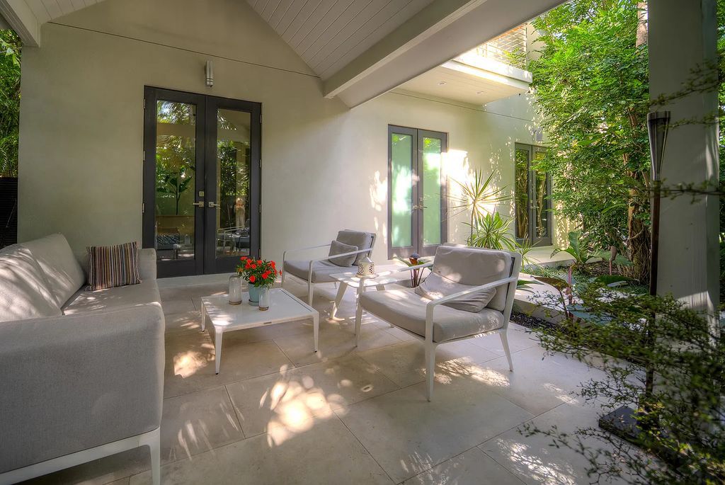 1025 Von Phister Street, Key West, Florida, is located in a sought-after neighborhood offering a tranquil escape. Both in the front and back yards, it is surrounded by lush tropical gardens.