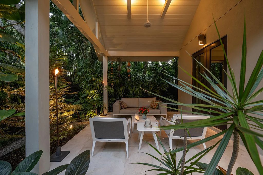 1025 Von Phister Street, Key West, Florida, is located in a sought-after neighborhood offering a tranquil escape. Both in the front and back yards, it is surrounded by lush tropical gardens.