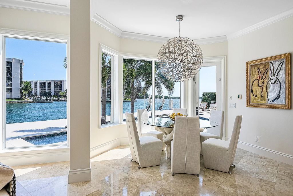 This exquisite 5 bedroom, 6 bathroom home is located on a prime waterfront lot in the highly sought-after area of Boca Raton, Florida. Built in 2003, 794 NE Harbour Drive boasts over 6,000 square feet of living space and sits on a spacious 0.22-acre lot. Upon entering the home, you'll be greeted by soaring ceilings and breathtaking water views that extend throughout the living areas, creating a bright and airy atmosphere.