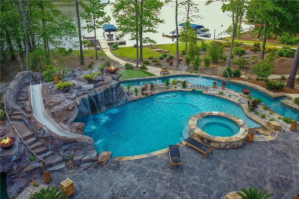 The Home in Greensboro features the most amazing “water-park” with a world-class swimming pool, lazy river, water-slide, waterfall, spa, now available for sale. This home located at 1381 Northwoods Dr, Greensboro, Georgia