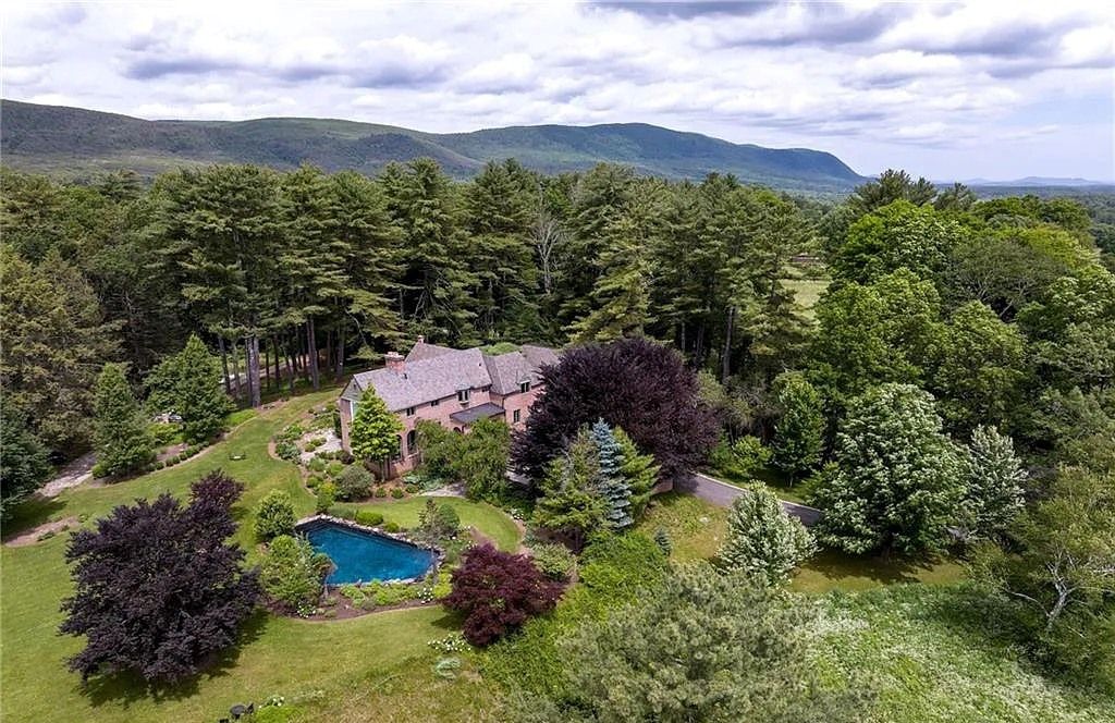 The Home in Salisbury boasts breathtaking views, specimen trees, and a tranquil ambiance, now available for sale. This home located at 69 Beaver Dam Rd, Salisbury, Connecticut