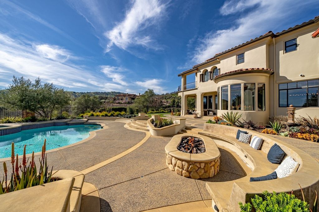 This Executive Estate is located at 1904 Zenato Pl, Pleasanton, California in the prestigious gated community of Ruby Hill, which features a Jack Nicklaus designed golf course. The property was built in 1999 and sits on a premium lot that measures 0.58 acres, offering breathtaking panoramic views of the Valley.