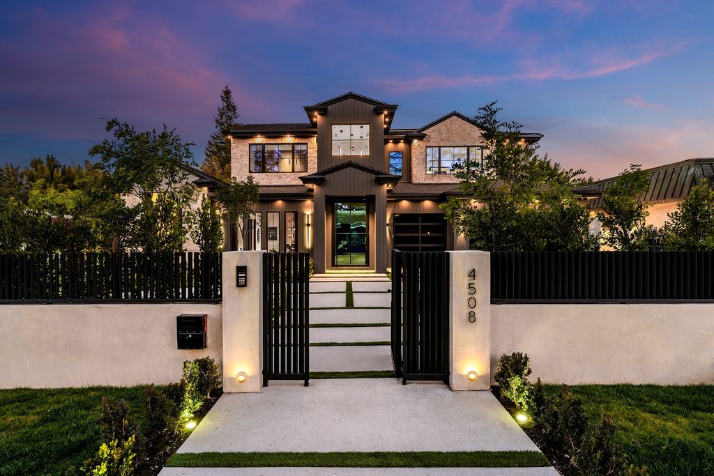 The recently built gated estate at 4508 Haskell Ave in Encino's prestigious Royal Oaks community is a true masterpiece of luxury and design. Upon entering the property, guests are welcomed by an impressive wide entry hallway with ultra-high ceilings and European oak floors. The hallway leads to the stunning living room with stone entertainment bars and a formal dining room with a fireplace and private patio.