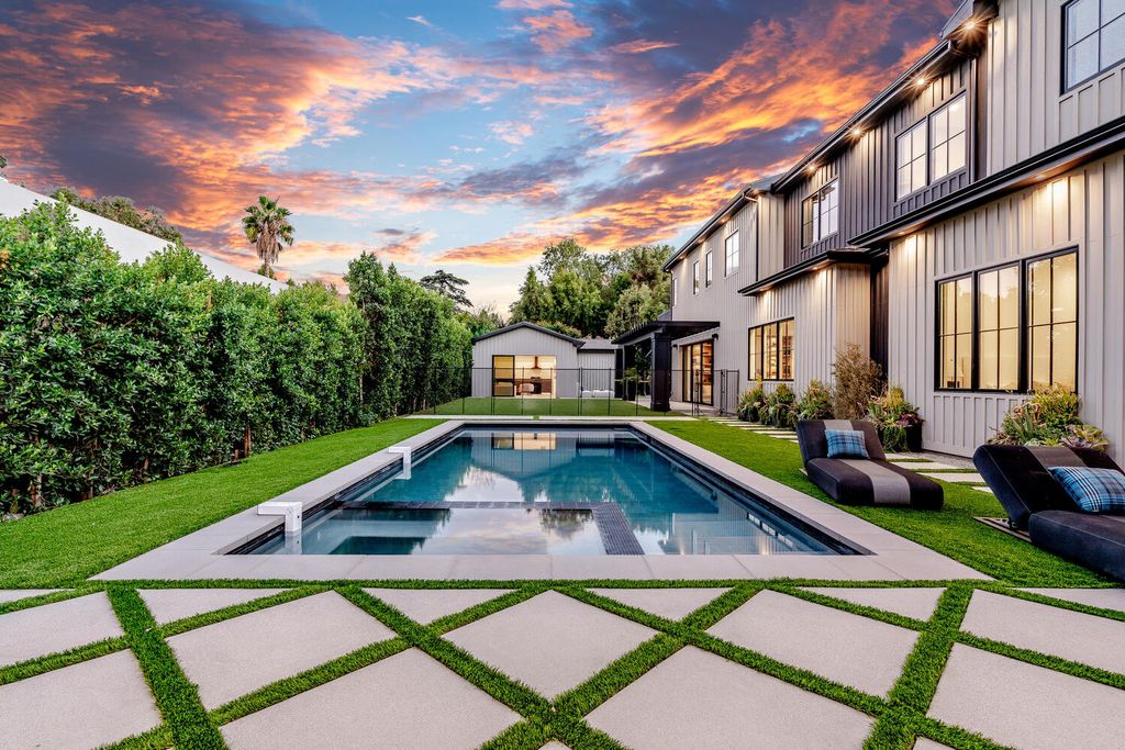 The property located at 5330 Amestoy Ave, Encino, CA 91316 is a newly built, world-class estate boasting six bedrooms, seven bathrooms, and 7,200 square feet of living space on a 0.44-acre lot. With captivating architecture, including soaring ceilings and an abundance of natural light, the property features a formal living room, a family room flowing seamlessly into a striking kitchen outfitted with custom cabinetry and top-of-the-line appliances, and a luxurious master suite with dual closets and a large balcony overlooking the stunning grounds.
