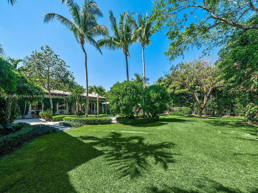 Experience the ultimate luxury living at 6655 SW 106th Street, Miami, Florida, where this enchanting tropical paradise is a true hidden gem, nestled in N Pinecrest surrounded by exotic green grounds. This stunning courtyd home welcomes you with water features, a grand foyer with dramatic staircase, and volume ceilings that exude luxury at its finest. 