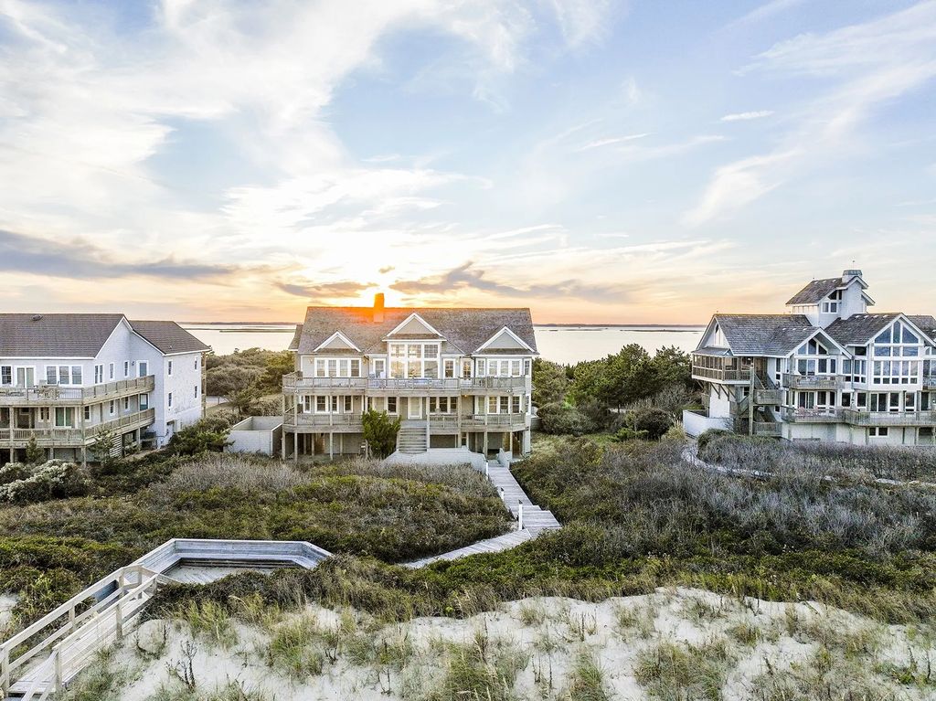 The Estate in Duck provides plenty of space for enjoying the sunrise over the ocean, now available for sale. This home located at 112 S Baum Trl, Duck, North Carolina