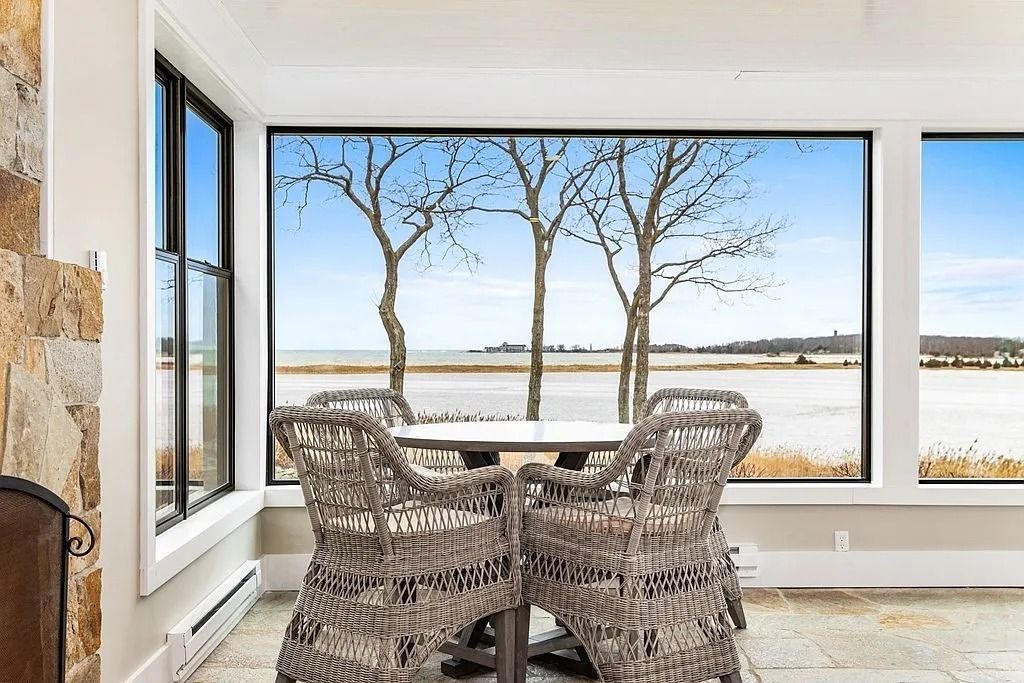 The Residence in Scituate features a full guest apartment, elevator, and panoramic harbor, ocean, marsh and woodland views, now available for sale. This home located at 20 Wood Island Rd, Scituate, Massachusetts