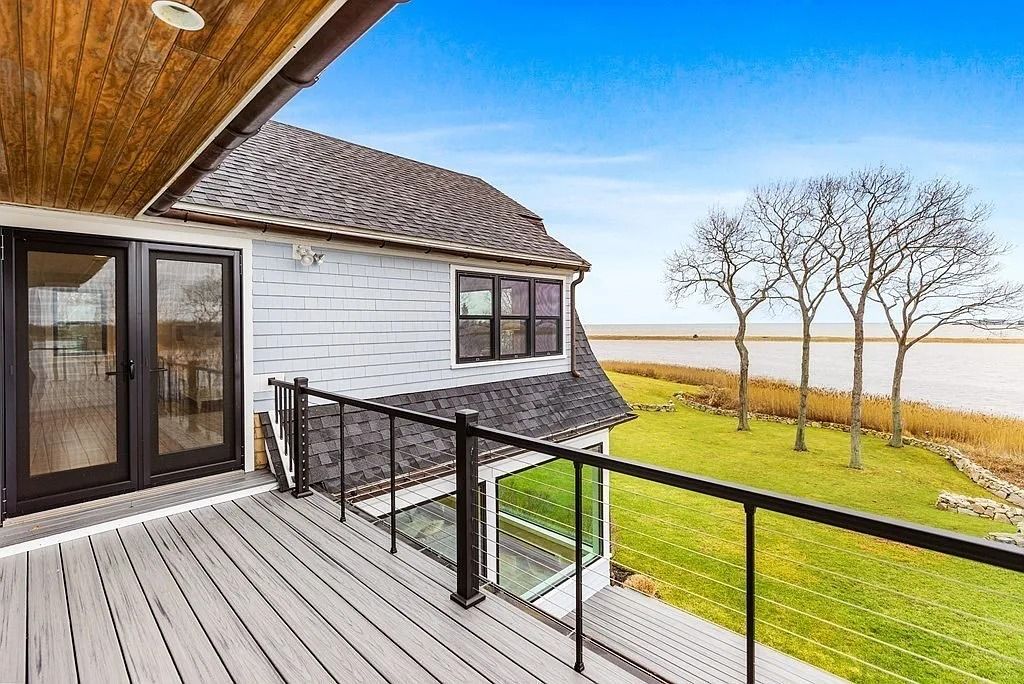 The Residence in Scituate features a full guest apartment, elevator, and panoramic harbor, ocean, marsh and woodland views, now available for sale. This home located at 20 Wood Island Rd, Scituate, Massachusetts