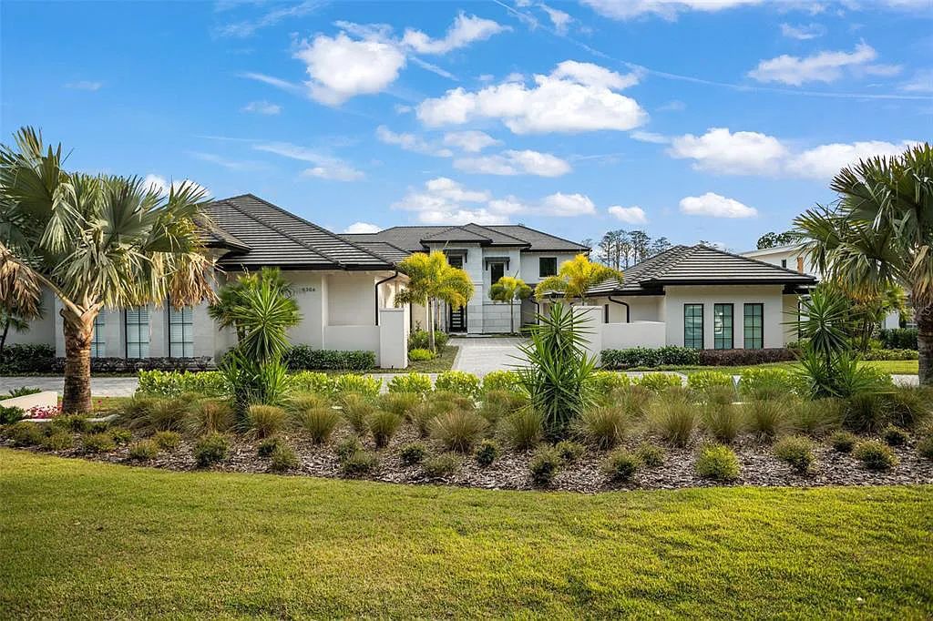 This luxurious lakefront mansion at 9306 Blanche Cove Drive in Windermere, Florida, is a custom-crafted masterpiece built for the ultimate sports enthusiast. The 5-bedroom, 8-bath home spans 14,856 square feet and includes a 6,060 square foot air-conditioned full-sized basketball court, a theater, an exercise room with sauna, and a two-story master closet.