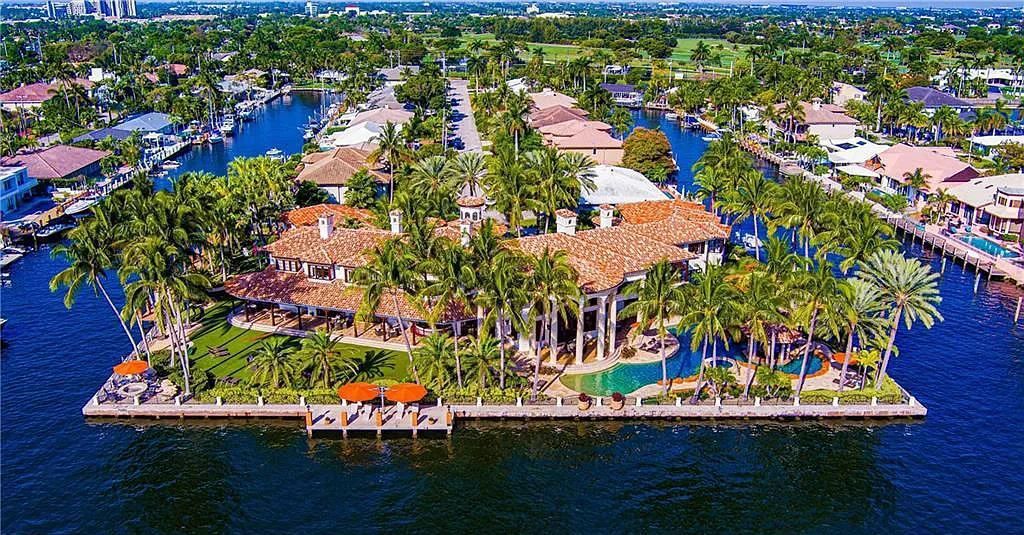 Introducing an extraordinary opportunity to own a gated Palatial Palm Beach-Inspired Point Estate located at 2900 NE 37th Street in the prestigious Coral Ridge County Club enclave of Fort Lauderdale, Florida. This stunning mansion is situated on over 1.09 acres of lush land and boasts 665 feet of full-service mega-yacht dockage, framing the property on three sides with amazing wrap-around water frontage.