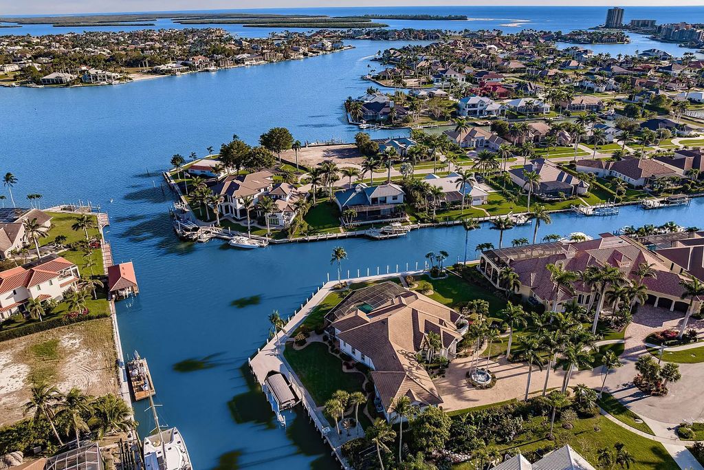 This luxurious waterfront estate located on 1451 Cutler Court, Marco Island, Florida, is a rare find, with only eight tip lots on all of Marco Island. Built in 1999, this custom-built JJ Baker home boasts four bedrooms, five bathrooms, and 3,868 square feet of living space on a 0.70-acre lot, with over 300 feet of waterfront and southern rear exposure.