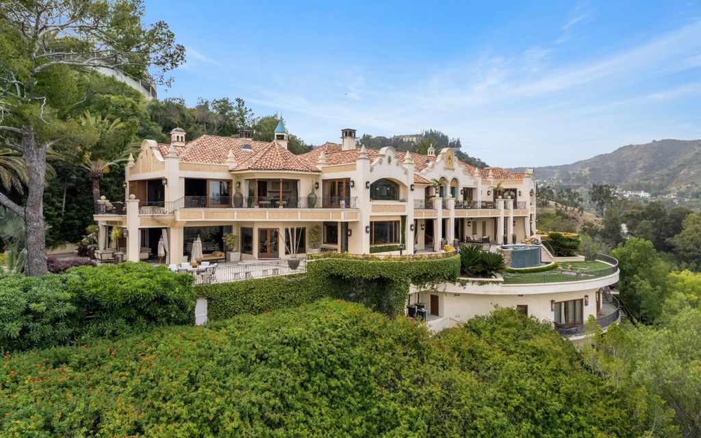 Experience opulent living in Beverly Hills' most desirable zip code with The Cielo Estate. This palatial Andalusian-style masterpiece features 9 bedrooms, 18 bathrooms, 21,000 sq. ft. living space, and 3.60 acres lot size. Enjoy breathtaking city and ocean views, a detached guest house, movie theatre, spa, gym, billiards room, bar, and a 75-yard pool with 3 waterfalls, 2 spas, a 35-foot water slide, and more.