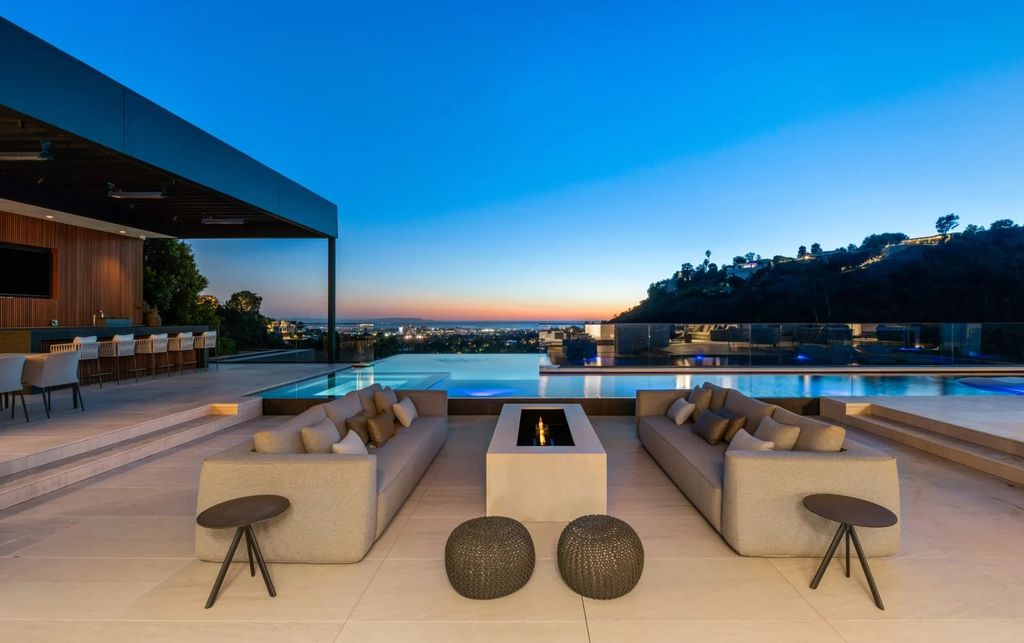 Look no further than 1035 Stradella Rd, a stunning property situated on a private hillside and boasting breathtaking city and ocean views. Built in 2021 and spanning over 12,000 square feet, this entertainer's paradise features 7 bedrooms, 14 bathrooms, and endless amenities for indoor-outdoor entertaining.