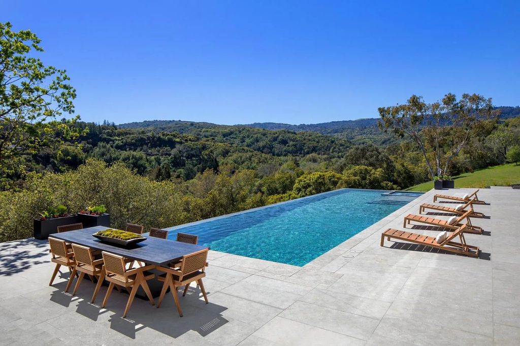 Located in the picturesque Portola Valley, 40 Firethorn Way is a stunning estate designed by renowned architects Swatt | Miers and completed in 2023 with meticulous attention to every detail. Boasting contemporary styling and magnificent 360-degree hillside views, this luxurious residence features generously proportioned interior spaces with disappearing walls of glass, custom finishes, and fixtures throughout.