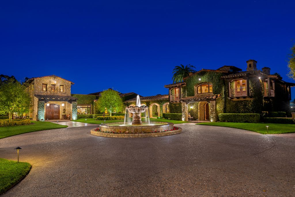 Indulge in the lavishness of a sprawling Mediterranean estate located on 4.71 acres in the sought-after Rancho Santa Fe. This private gated property boasts a grand Tuscan villa with a circular drive featuring a serene fountain and four separate stone and vine-covered structures surrounded by lush greenery.
