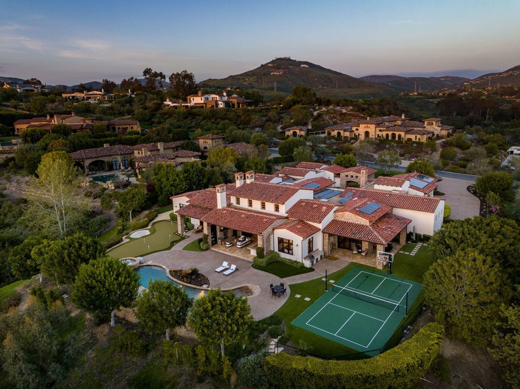 6367 Calle Ponte Bella Home in Rancho Santa Fe, California. This luxurious custom residence is located in the Estates enclave of The Bridges at Rancho Santa Fe. The 5-bedroom, 5.5-bath home spans approx. 9,788 sq.ft. on one level and boasts high-end features such as a chef-worthy kitchen, theater, wine cellar, and pool with a spa and waterfall. 