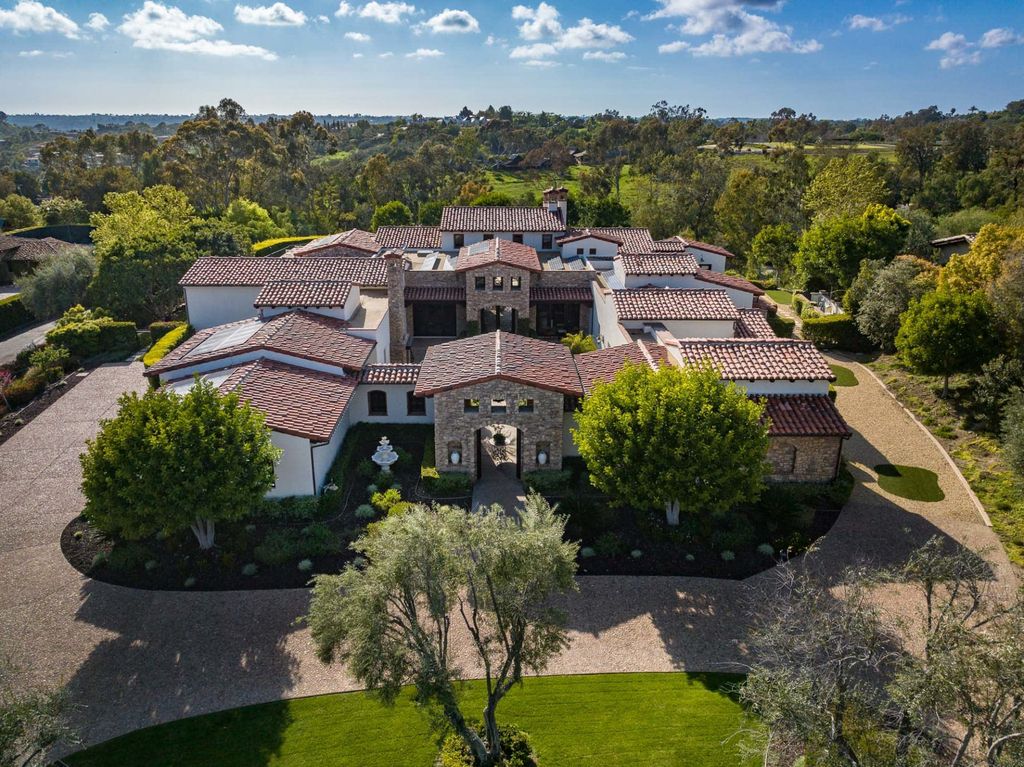 6367 Calle Ponte Bella Home in Rancho Santa Fe, California. This luxurious custom residence is located in the Estates enclave of The Bridges at Rancho Santa Fe. The 5-bedroom, 5.5-bath home spans approx. 9,788 sq.ft. on one level and boasts high-end features such as a chef-worthy kitchen, theater, wine cellar, and pool with a spa and waterfall. 