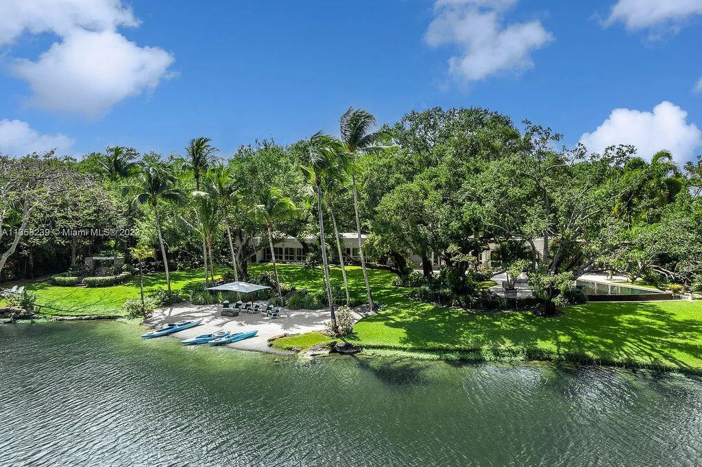 Experience unparalleled luxury in this lakefront estate located at 10201 Sabal Palm Avenue, Coral Gables, Florida. With 5 bedrooms, 7 bathrooms, and 2 half-bathrooms, this sprawling 9,266 sq ft home boasts an infinity saltwater pool, custom-designed kitchen, and floor-to-ceiling windows.