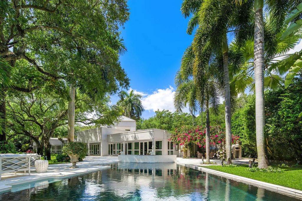 Experience unparalleled luxury in this lakefront estate located at 10201 Sabal Palm Avenue, Coral Gables, Florida. With 5 bedrooms, 7 bathrooms, and 2 half-bathrooms, this sprawling 9,266 sq ft home boasts an infinity saltwater pool, custom-designed kitchen, and floor-to-ceiling windows.