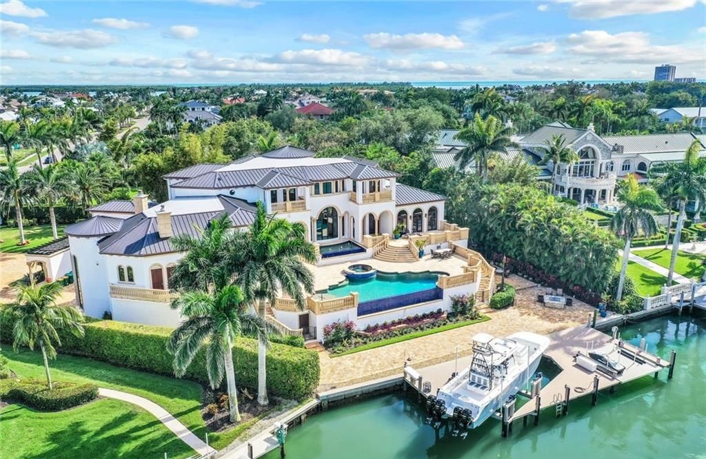 This is a stunning, one-of-a-kind estate residence located at 820 S Barfield Drive, Marco Island, Florida. It boasts 5 beds, 7 baths, and 9,188 sq ft of living space on a private, gated 0.87-acre lot with expansive views of Roberts Bay.