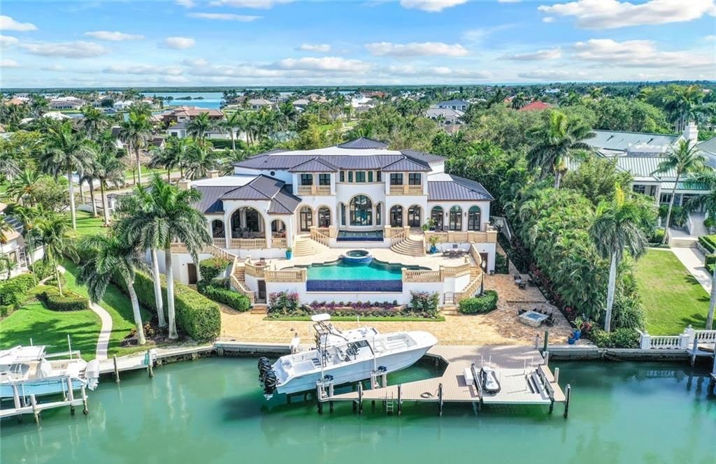 This is a stunning, one-of-a-kind estate residence located at 820 S Barfield Drive, Marco Island, Florida. It boasts 5 beds, 7 baths, and 9,188 sq ft of living space on a private, gated 0.87-acre lot with expansive views of Roberts Bay.