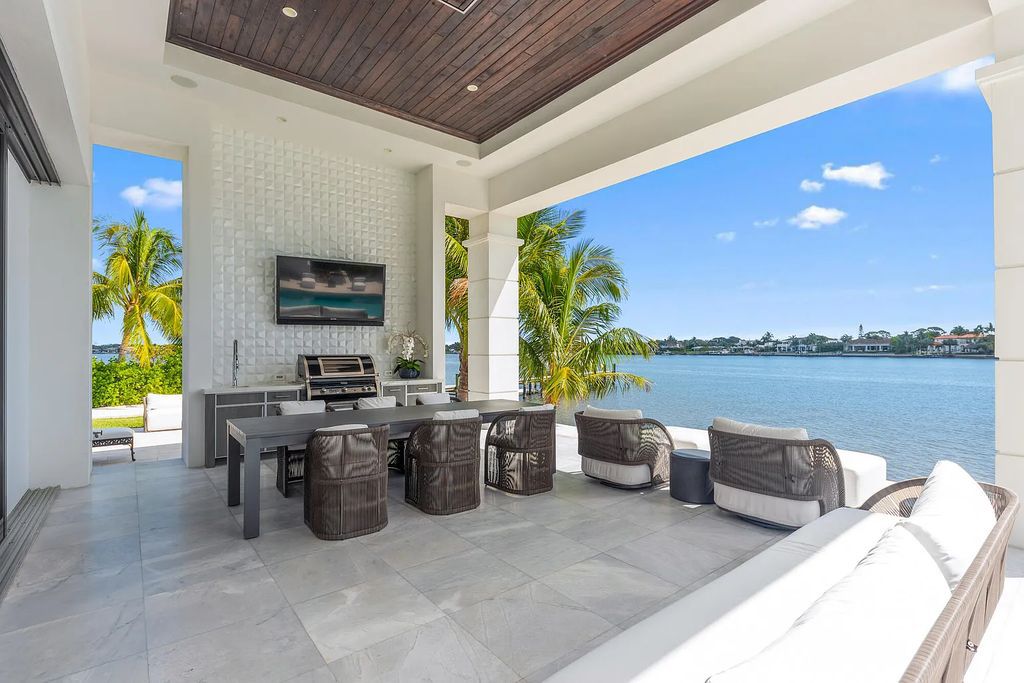 Welcome to 8 Bamboo Lane, Jupiter, Florida, a luxurious contemporary British West Indies home. Built in 2016, this 4-bed, 8-bath, 6,599 sq ft home boasts modern flair and luxury finishes throughout. With 200' of riverfront, it offers breathtaking water views from every room.