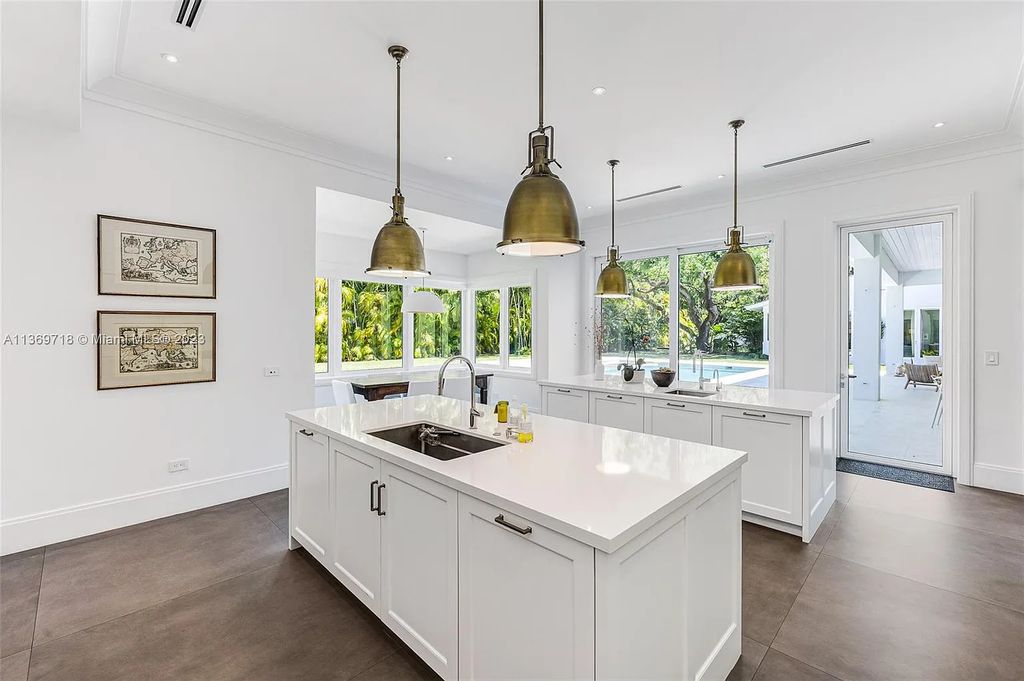 5501 Snapper Creek Road is a luxurious 6-bedroom, 8-bathroom estate located in the sought-after Coral Gables, Florida area. This stunning 2021 one-story home sits on a sprawling 1.29-acre corner lot, surrounded by mature oak trees and lush landscaping.