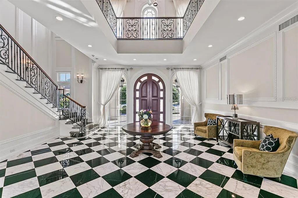 Experience luxury living at 5507 Worsham Court in Windermere, Florida. This stunning custom estate offers 5 beds, 9 baths, and an expansive living space of 10,200 sqft, overlooking the 14th green of Isleworth Golf and Country Club.