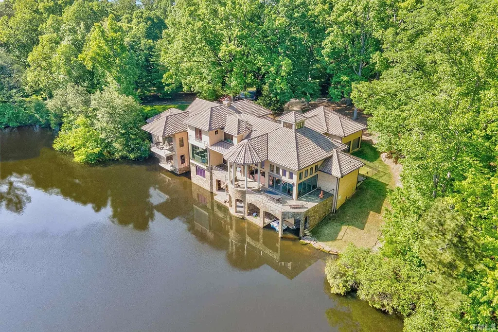 This stunning property located at 102 Anna Lake Ln, Cary, NC offers an exceptional lakeside living experience on nearly 8 acres of land. Situated on a private lake, this magnificent estate is just a short drive away from downtown Cary, hiking trails, and other amenities. With its close proximity to RTP and RDU Airport, commuting is a breeze. 