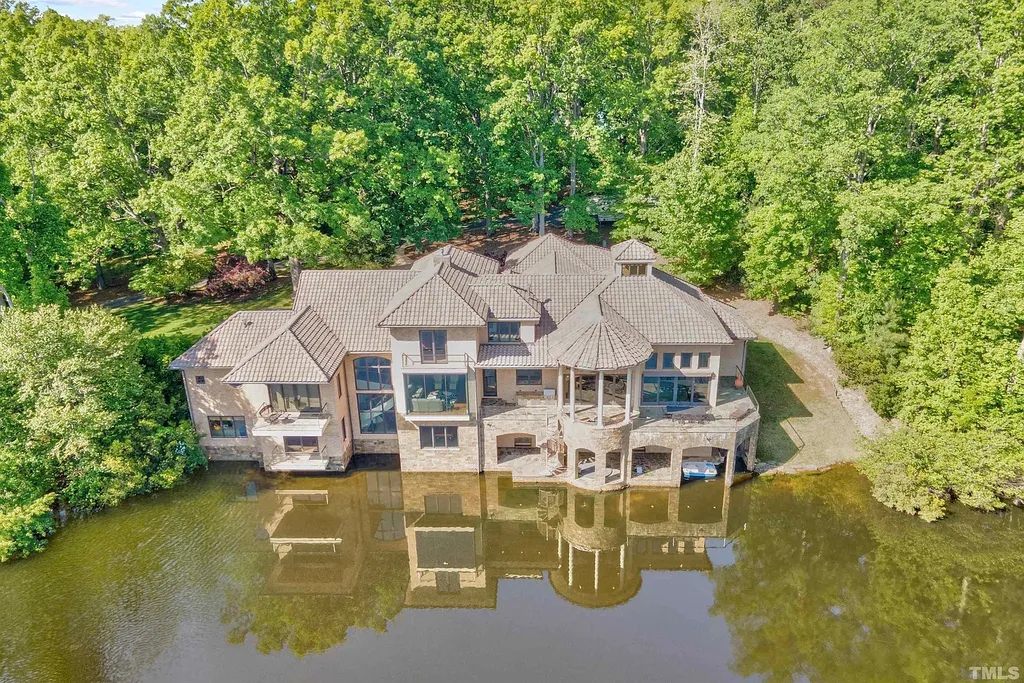 This stunning property located at 102 Anna Lake Ln, Cary, NC offers an exceptional lakeside living experience on nearly 8 acres of land. Situated on a private lake, this magnificent estate is just a short drive away from downtown Cary, hiking trails, and other amenities. With its close proximity to RTP and RDU Airport, commuting is a breeze. 