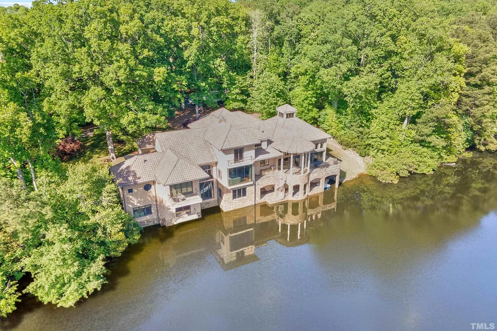 This stunning property located at 102 Anna Lake Ln, Cary, NC offers an exceptional lakeside living experience on nearly 8 acres of land. Situated on a private lake, this magnificent estate is just a short drive away from downtown Cary, hiking trails, and other amenities. With its close proximity to RTP and RDU Airport, commuting is a breeze. 