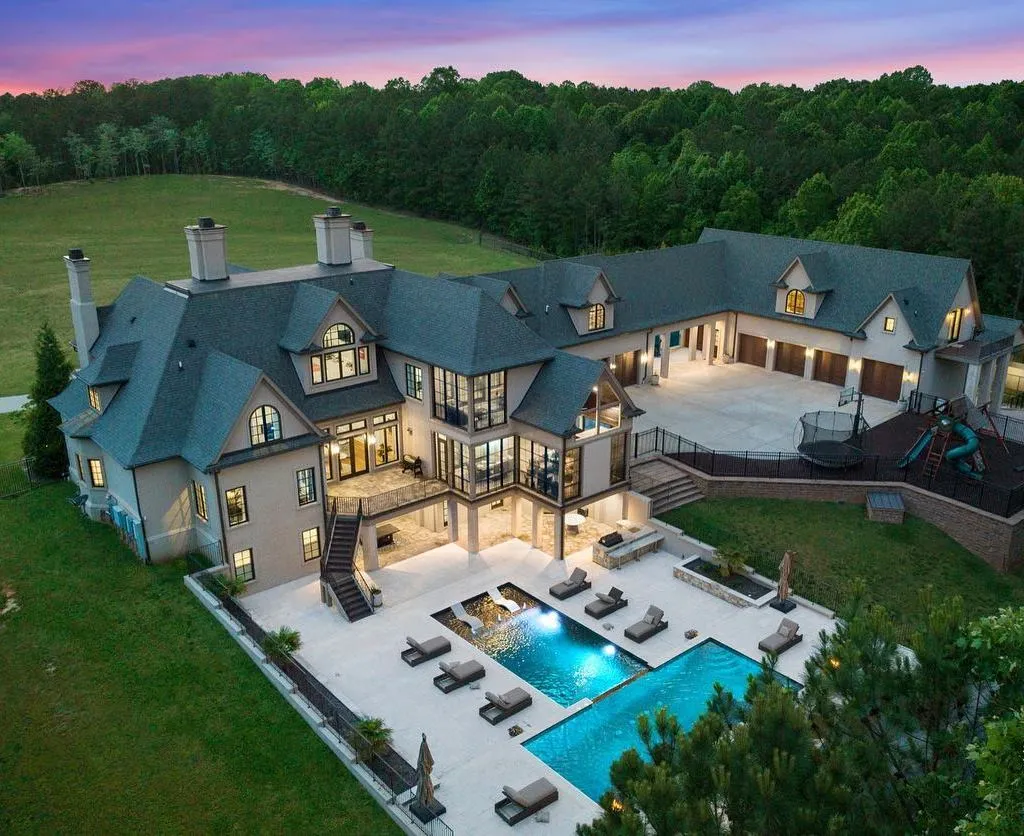 Discover unparalleled luxury living in this secluded and prestigious 14-acre estate nestled in the prime north Raleigh area. This remarkable property offers a unique blend of comfort and sophistication, boasting lavish amenities, meticulously designed interiors, a captivating backyard oasis, an expansive 11-car garage, 6 fireplaces, a sports court, geothermal heating/cooling, a whole-house generator and RO system, central vacuum, tankless water heaters, a theater, a gym with sauna, and a state-of-the-art Control4 system. Indulge in the opulence of the primary suite featuring a private TV/sitting room with a linear fireplace, a secluded porch, a dedicated laundry room, a luxurious marble bath with a double jetted tub, dual water closets, and dual closets adorned with a center island and exquisite crystal chandeliers. Relish in the outdoor splendor offered by the multilevel heated saltwater pool with a mesmerizing waterfall, an elevated spa, an expansive limestone pool deck complemented by an outdoor grill station, and a separate pool house. This exceptional estate is a true rarity, meticulously crafted with attention to every detail, providing an unmatched experience unlike anything you have ever seen before!