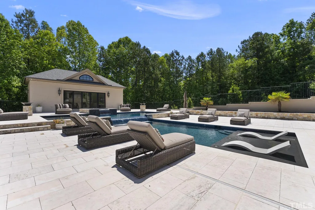 Discover unparalleled luxury living in this secluded and prestigious 14-acre estate nestled in the prime north Raleigh area. This remarkable property offers a unique blend of comfort and sophistication, boasting lavish amenities, meticulously designed interiors, a captivating backyard oasis, an expansive 11-car garage, 6 fireplaces, a sports court, geothermal heating/cooling, a whole-house generator and RO system, central vacuum, tankless water heaters, a theater, a gym with sauna, and a state-of-the-art Control4 system. Indulge in the opulence of the primary suite featuring a private TV/sitting room with a linear fireplace, a secluded porch, a dedicated laundry room, a luxurious marble bath with a double jetted tub, dual water closets, and dual closets adorned with a center island and exquisite crystal chandeliers. Relish in the outdoor splendor offered by the multilevel heated saltwater pool with a mesmerizing waterfall, an elevated spa, an expansive limestone pool deck complemented by an outdoor grill station, and a separate pool house. This exceptional estate is a true rarity, meticulously crafted with attention to every detail, providing an unmatched experience unlike anything you have ever seen before!