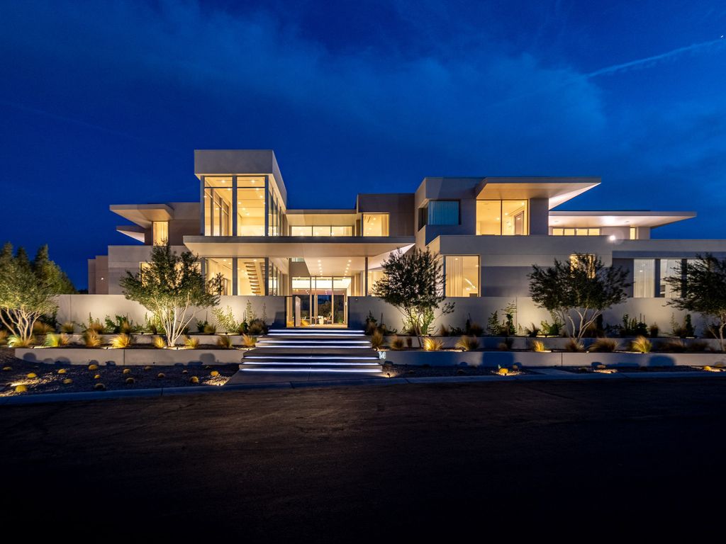 14 Magic Stone Lane Home in Las Vegas, Nevada. This stunning property boasts six spacious bedrooms, ten opulent bathrooms, and an enormous 12-car garage. The home's architecture is truly noteworthy, with natural stone used for the main kitchen countertop, fireplaces, shower slabs, and accent walls, adding to the lavish ambiance.