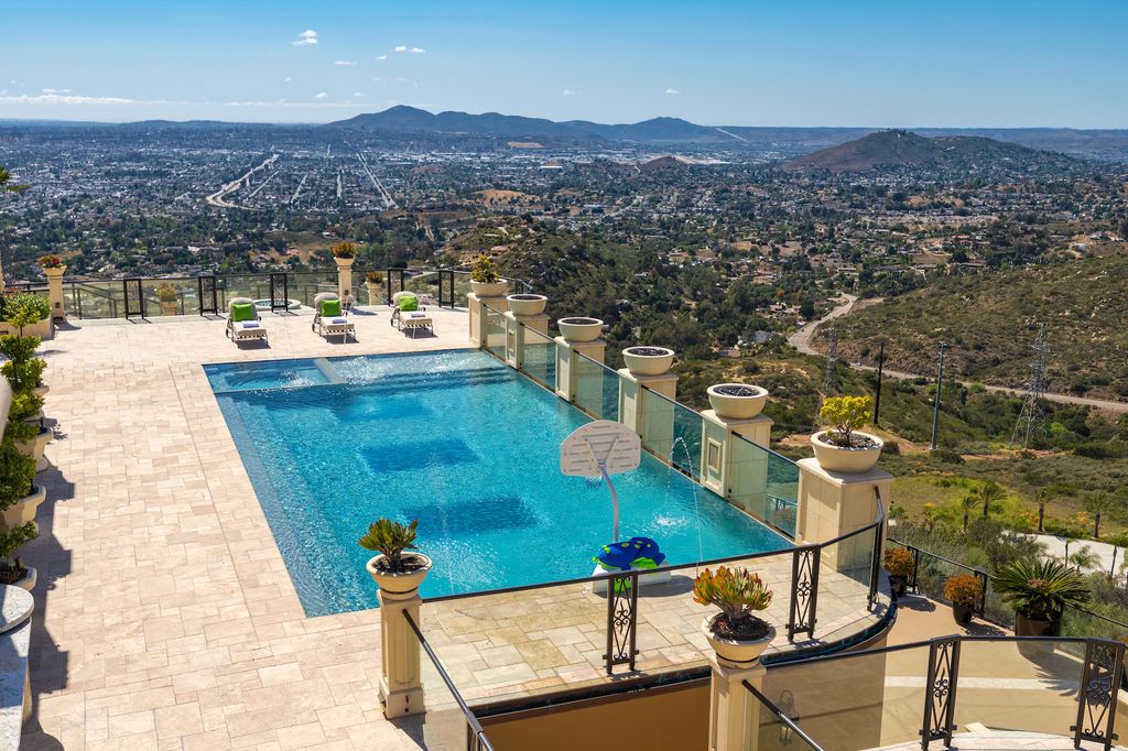 1903 Saxton Lane Home in El Cajon, California. Discover unparalleled luxury living in this custom-built, handcrafted mountaintop estate with unobstructed views. Designed by renowned architect John Jensen AIA and built by Tony Mezain AME Proline Inc, this 13,631 sqft retreat features 5 bedrooms, 9 bathrooms, and exquisite attention to detail. 
