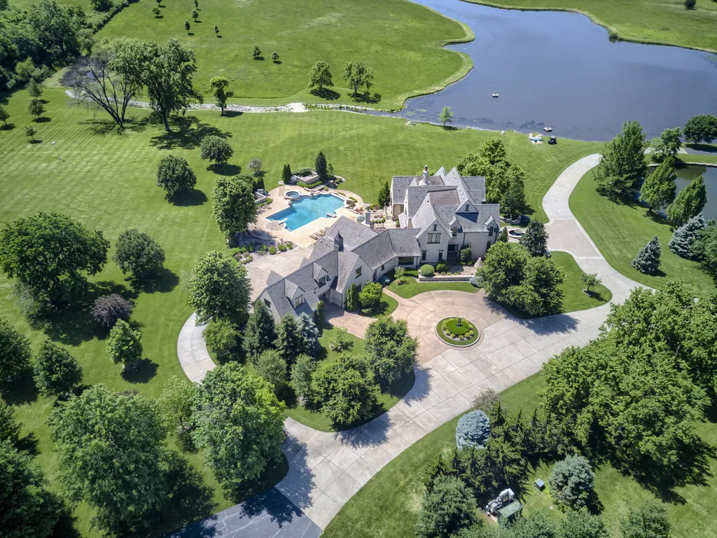 20485 Antioch Road Home in Bucyrus, Kansas. Discover this stunning 29-acre estate that offers breathtaking views and a relaxed country setting. Built by the renowned architect Lyle Holthaus, this estate exudes luxury and attention to detail at every turn. Nestled in a picturesque countryside, the custom-built home welcomes you with a private gate, a serene pond, beautiful stonework, a captivating water feature, and a fabulous entryway.