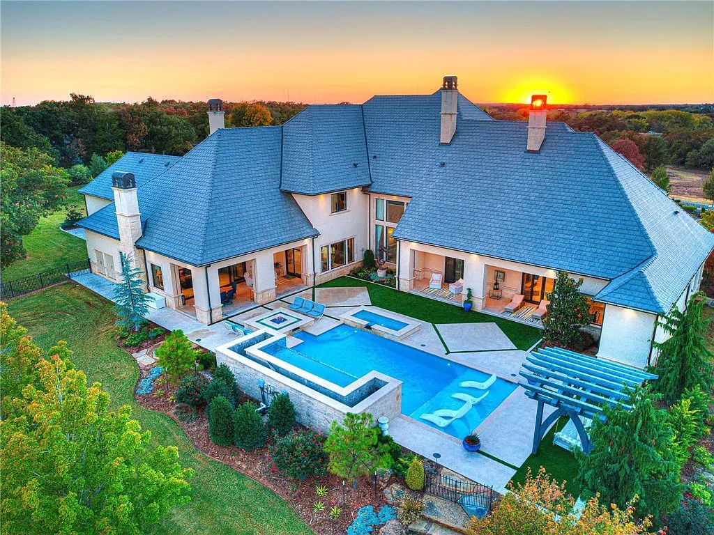 308 Deep Fork Circle, Arcadia, Oklahoma. This ultra-luxury home in Sugar Hill boasts multiple outdoor living spaces, water features, and extensive landscaping, providing privacy and exclusivity. The house features a gourmet kitchen, wine cellar, game room, and THX certified home theater. 