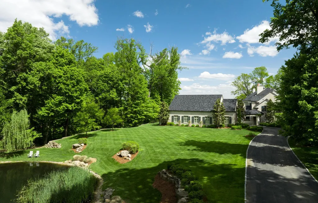 3758 Upper River Road Home in Louisville, Kentucky. LimeRidge is a stunning residence surrounded by 10+ acres of landscaped beauty and offering breathtaking views of the Ohio River Valley. This Belgian-inspired estate features an exceptional indoor-outdoor design with an open floor plan, walls of windows, and luxurious amenities. 