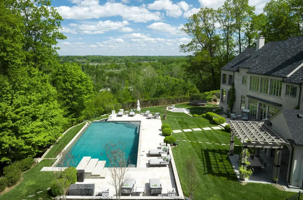 3758 Upper River Road Home in Louisville, Kentucky. LimeRidge is a stunning residence surrounded by 10+ acres of landscaped beauty and offering breathtaking views of the Ohio River Valley. This Belgian-inspired estate features an exceptional indoor-outdoor design with an open floor plan, walls of windows, and luxurious amenities. 