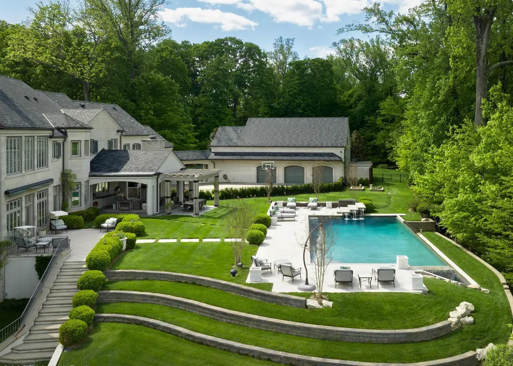 3758 Upper River Road Home in Louisville, Kentucky. LimeRidge is a stunning residence surrounded by 10+ acres of landscaped beauty and offering breathtaking views of the Ohio River Valley. This Belgian-inspired estate features an exceptional indoor-outdoor design with an open floor plan, walls of windows, and luxurious amenities. 