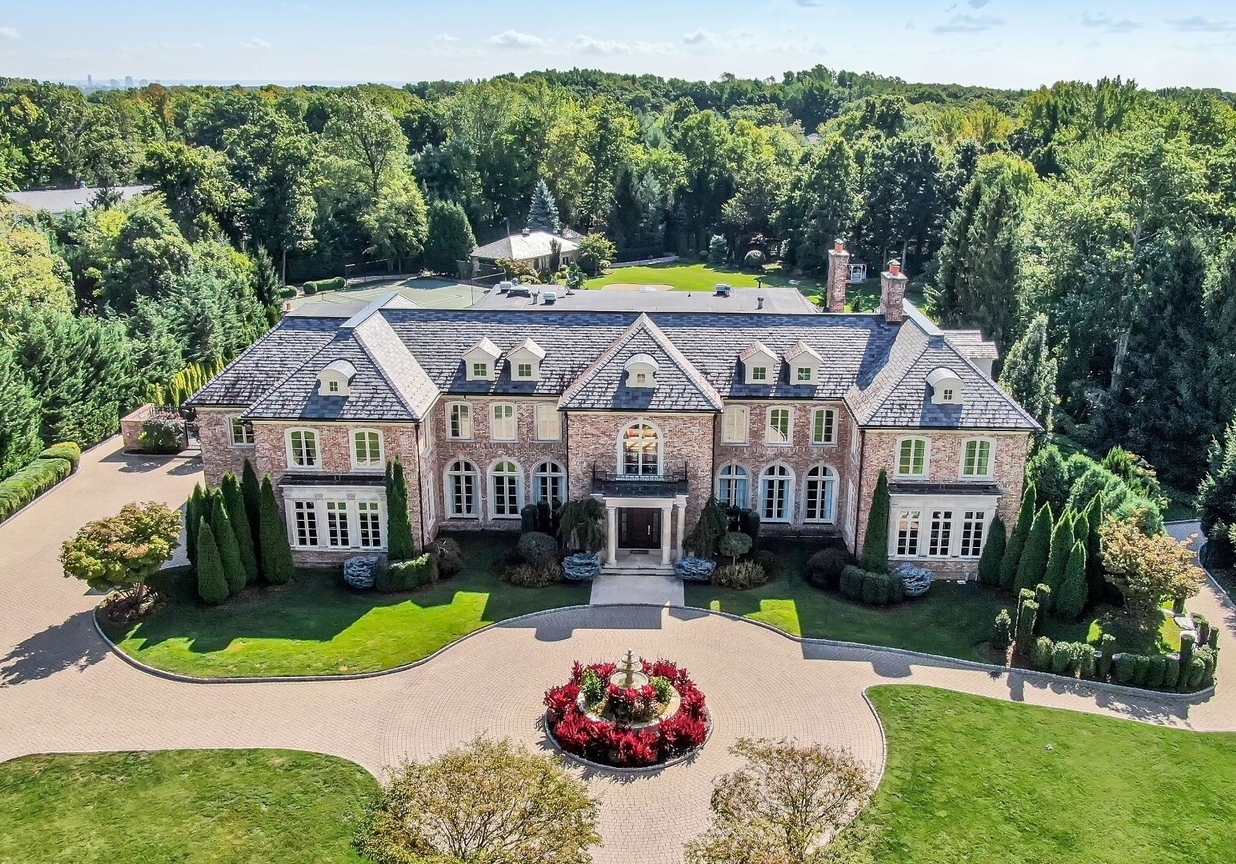 4 Stone Tower Drive Home in Alpine, New Jersey. Discover the epitome of luxury living at the majestic Alpine estate, one of the finest homes in Northern Bergen County. Set on 4 gated manicured acres in Rio Vista, this impeccably designed manor by James Paragono showcases architectural excellence and meticulous craftsmanship. With 22,782 square feet of opulent living space spread across 4 levels, this estate boasts 12' ceilings, luxurious amenities, and breathtaking features, including a pool, cabana, tennis court, guest house, and putting green. The residence offers garage parking for 8 cars, an elevator servicing all floors, 25 rooms, a new Salerno kitchen, 8 bedrooms, 9 full and 3 half baths, bowling alleys, a home theater, a commercial generator, and state-of-the-art high-efficiency furnaces.