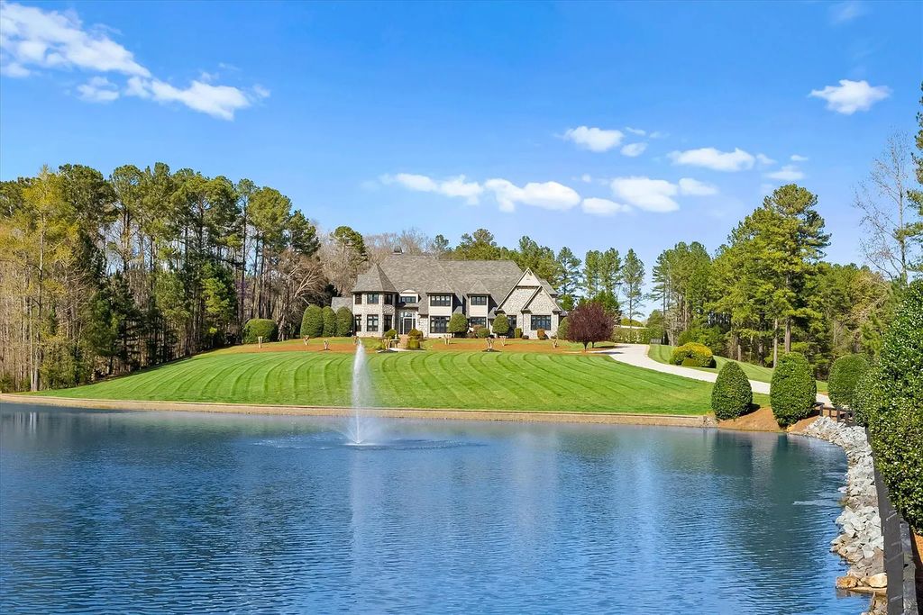 525 Lake Lynn Road Home in Concord, North Carolina. Explore this stunning European-inspired estate set on 53+ acres with imported finishes and 7ft thick footings. Boasting over 9000 sqft of luxurious living space, the home features 5 beds, 4.5 baths, a game room, living room, great room with mahogany beamed ceilings, and a gourmet kitchen with gas appliances.