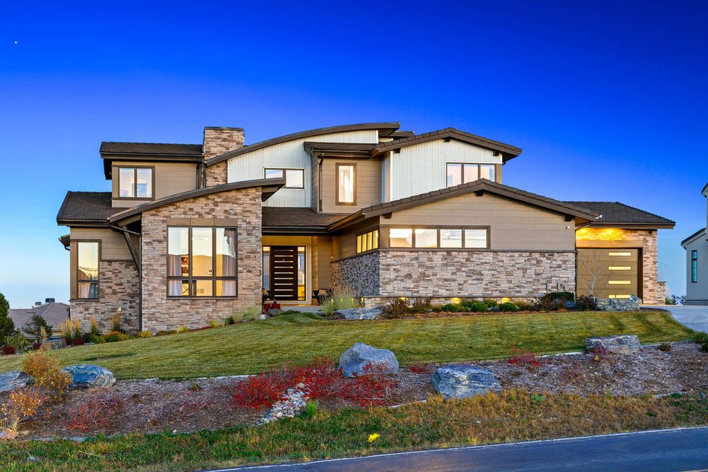 6428 Country Club Drive Home in Castle Rock, Colorado. Experience Colorado country club living at its finest in the prestigious Village at Castle Pines. This Mountain Modern Sterling Custom Home offers breathtaking views of Pikes Peak and Mt Evans, a Jack Nicklaus golf course, and 24/7 gated security. With an open concept design, this home features impressive details like Glulam beams, a gas fireplace, and White Oak Hardwood floors.