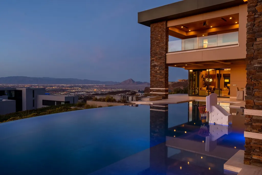 This extraordinary estate located at 761 Dragon Ridge Drive in Henderson, NV offers an unparalleled level of luxury and sophistication. Situated within the exclusive 9-lot enclave in Macdonald Highlands, this magnificent residence is nestled on a sprawling 1.23-acre lot, providing ample space and privacy.