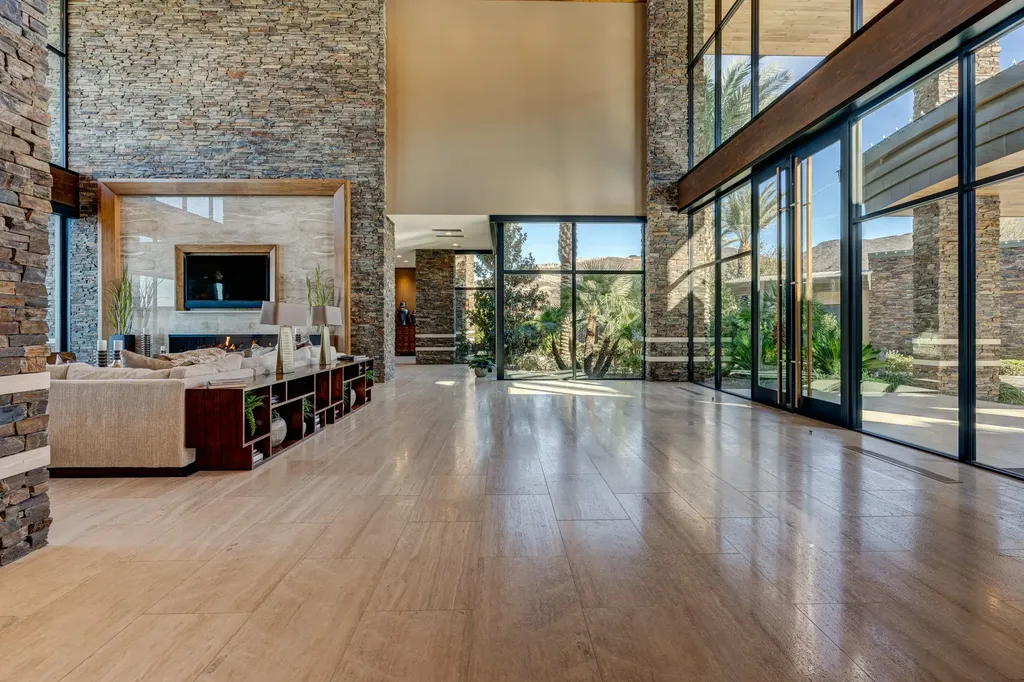 This extraordinary estate located at 761 Dragon Ridge Drive in Henderson, NV offers an unparalleled level of luxury and sophistication. Situated within the exclusive 9-lot enclave in Macdonald Highlands, this magnificent residence is nestled on a sprawling 1.23-acre lot, providing ample space and privacy.