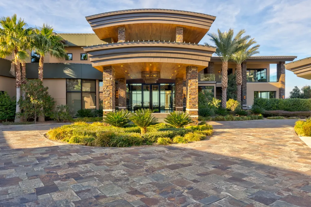 This extraordinary estate located at 761 Dragon Ridge Drive in Henderson, NV offers an unparalleled level of luxury and sophistication. Situated within the exclusive 9-lot enclave in Macdonald Highlands, this magnificent residence is nestled on a sprawling 1.23-acre lot, providing ample space and privacy.