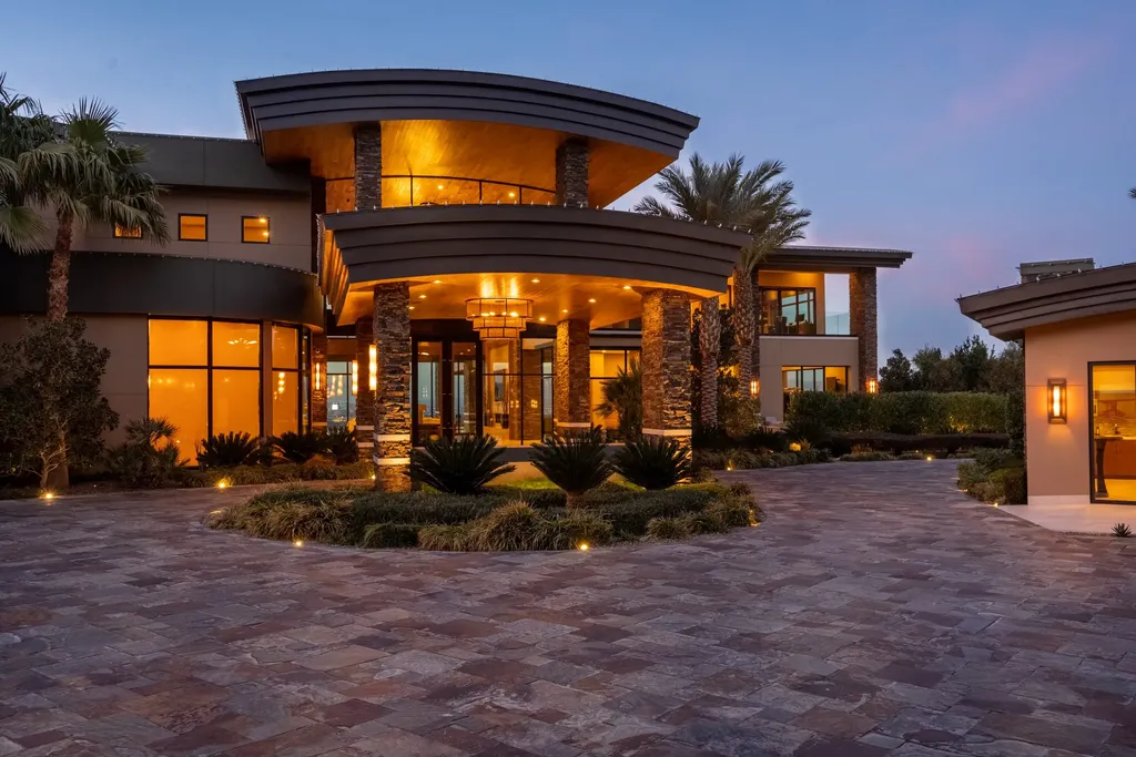 This extraordinary estate located at 761 Dragon Ridge Drive in Henderson, NV offers an unparalleled level of luxury and sophistication. Situated within the exclusive 9-lot enclave in Macdonald Highlands, this magnificent residence is nestled on a sprawling 1.23-acre lot, providing ample space and privacy.