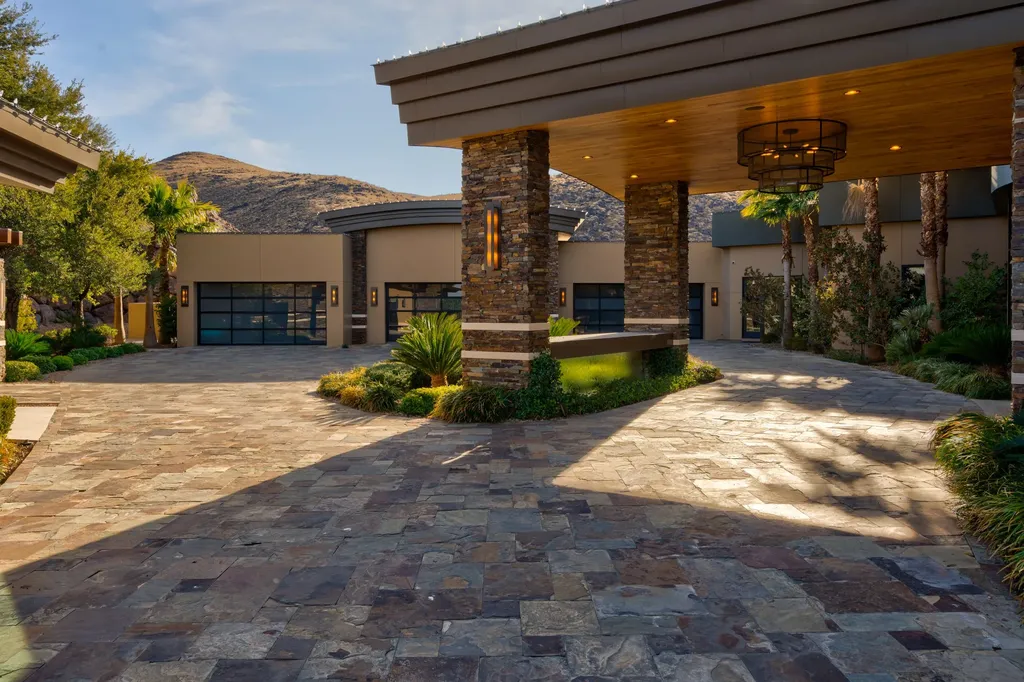 This extraordinary estate located at 761 Dragon Ridge Drive in Henderson, NV offers an unparalleled level of luxury and sophistication. Situated within the exclusive 9-lot enclave in Macdonald Highlands, this magnificent residence is nestled on a sprawling 1.23-acre lot, providing ample space and privacy.